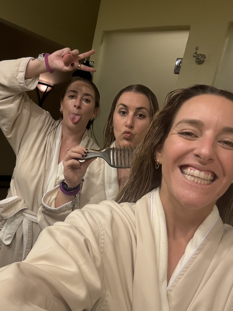Three friends goofing off in bathrobes at the spa